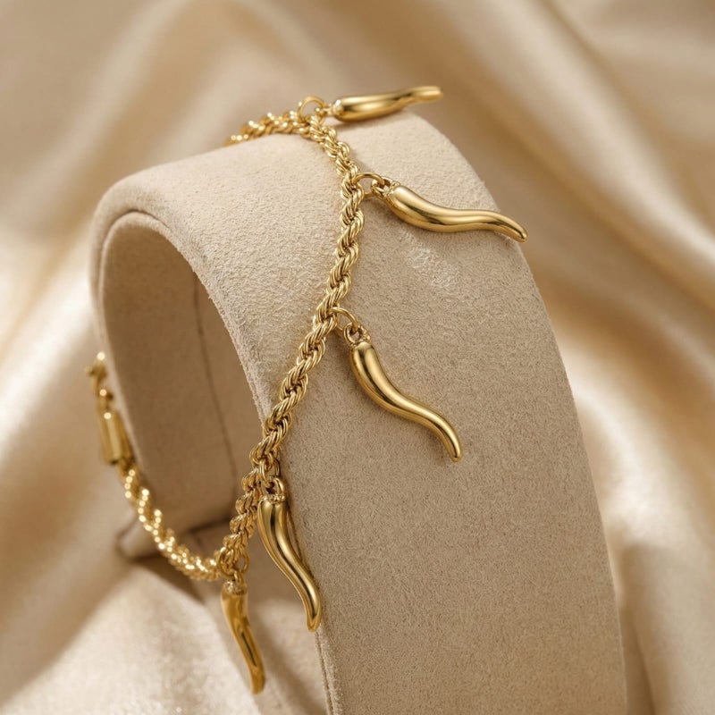 A stylish gold bracelet made of rust-resistant stainless steel, with a braided "rope" design from which attractive "pepper horn" pendants dangle, with an adjustable clasp to fit you. - Image 5